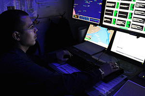 Intelligence Specialist 1st Class Carlos E. Cruz monitors automatic identification systems aboard the aircraft carrier USS George H.W. Bush (CVN 77). George H.W. Bush is deployed to the U.S. 5th Fleet area of responsibility on its first operational deployment conducting maritime security operations and support missions as part of Operations Enduring Freedom and New Dawn. (U.S. Navy photo by Mass Communication Specialist Seaman K. Cecelia Engrums/Released)