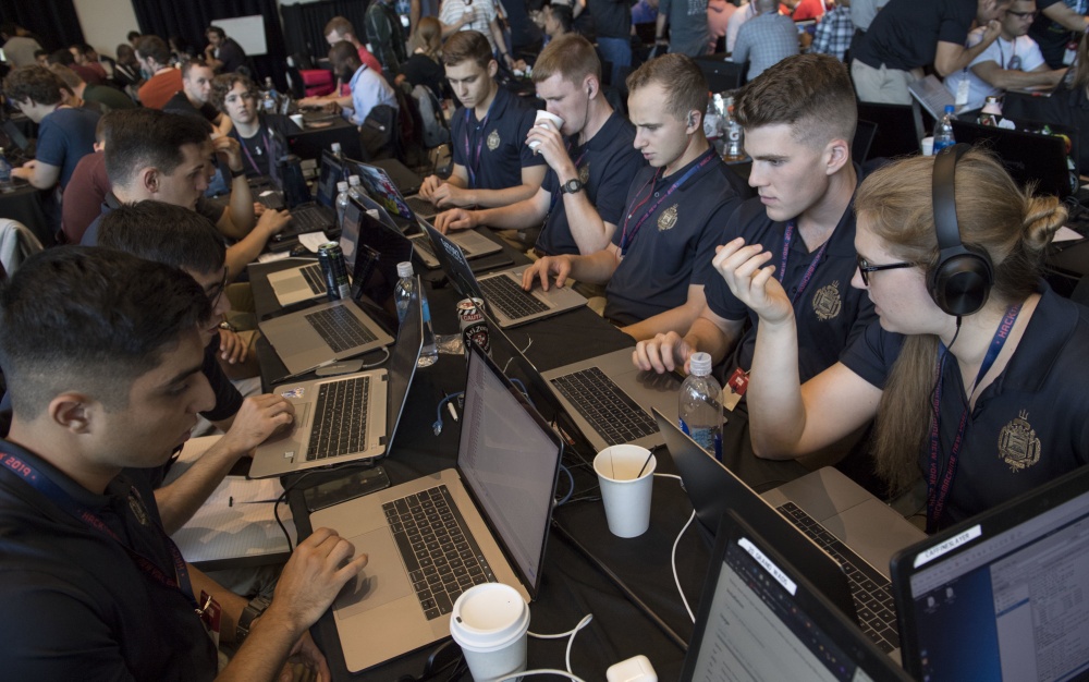 NEW YORK (Sept. 7, 2019) A team of Naval Midshipmen and Air Force Airmen from the Naval Academy and Air Force Academy participate in track one during HacktheMachine competition at the Brooklyn Navy Yard in New York City, Sept. 7, 2019. 