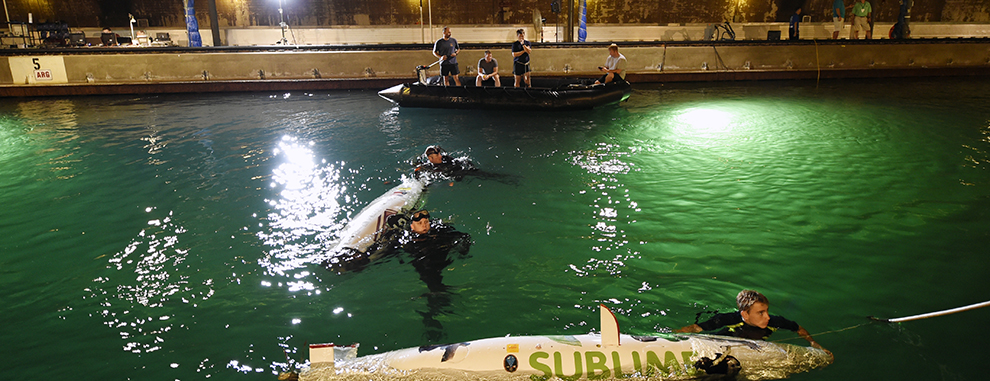 Navy divers from the Explosive Ordnance Disposal Technical Division at Indian Head, Md., assist student teams with their human-powered submarines during the 13th International Human-Powered Submarine Race (ISR) being held in the David Taylor Model Basin at the Naval Surface Warfare Center Carderock Division.