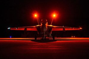 F/A-18 aircraft on flight deck at night