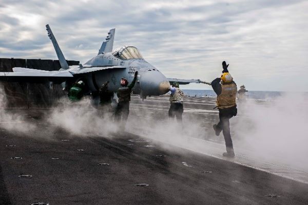 An F/A-18 aircraft on the flight deck prior to takeoff