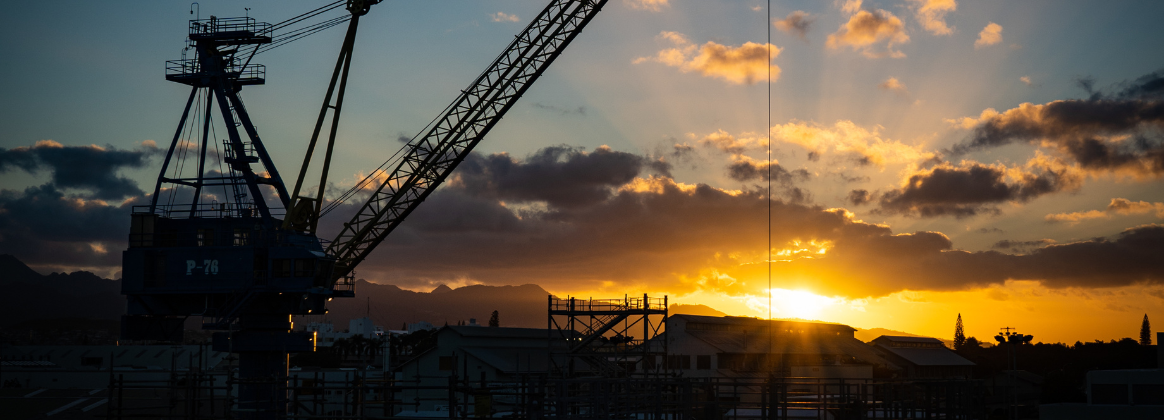 Sunrise over the Ko`olau Mountains with portal crane P-76 in the foreground.
