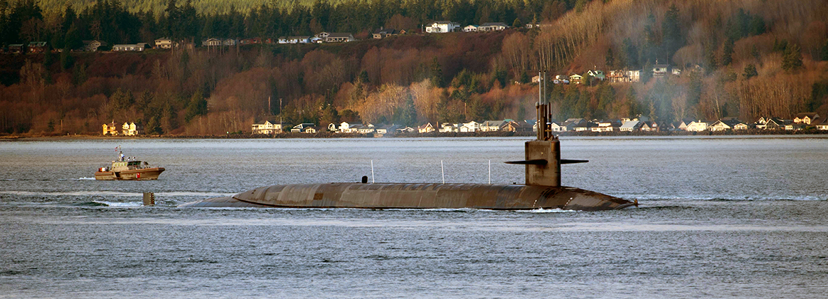 The Ohio-class ballistic missile submarine USS Nevada (SSBN 733) transits the Hood Canal as the boat departs its homeport of Naval Base Kitsap-Bangor, Washington for a scheduled patrol Dec. 16, 2021. 