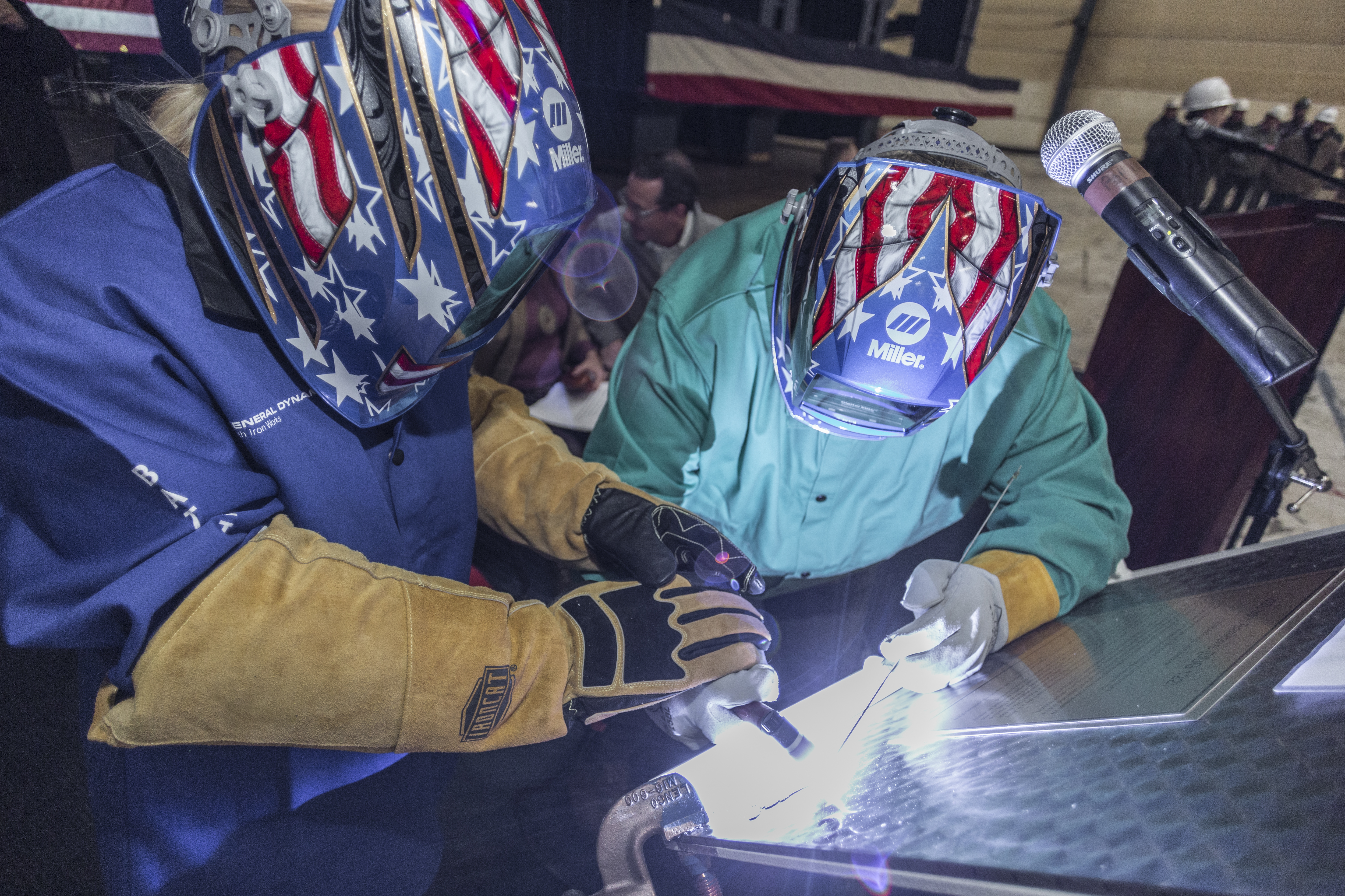 BATH, Maine (Jan. 10, 2020) Ship sponsor Ms. Ryan Manion welds her initials into a steel plate during a keel authentication ceremony for the future USS John Basilone (DDG 122). (Photo courtesy of General Dynamics Bath Iron Works) BATH, Maine (Jan. 10, 2020) Ship sponsor Ms. Ryan Manion welds her initials into a steel plate during a keel authentication ceremony for the future USS John Basilone (DDG 122). (Photo courtesy of General Dynamics Bath Iron Works)