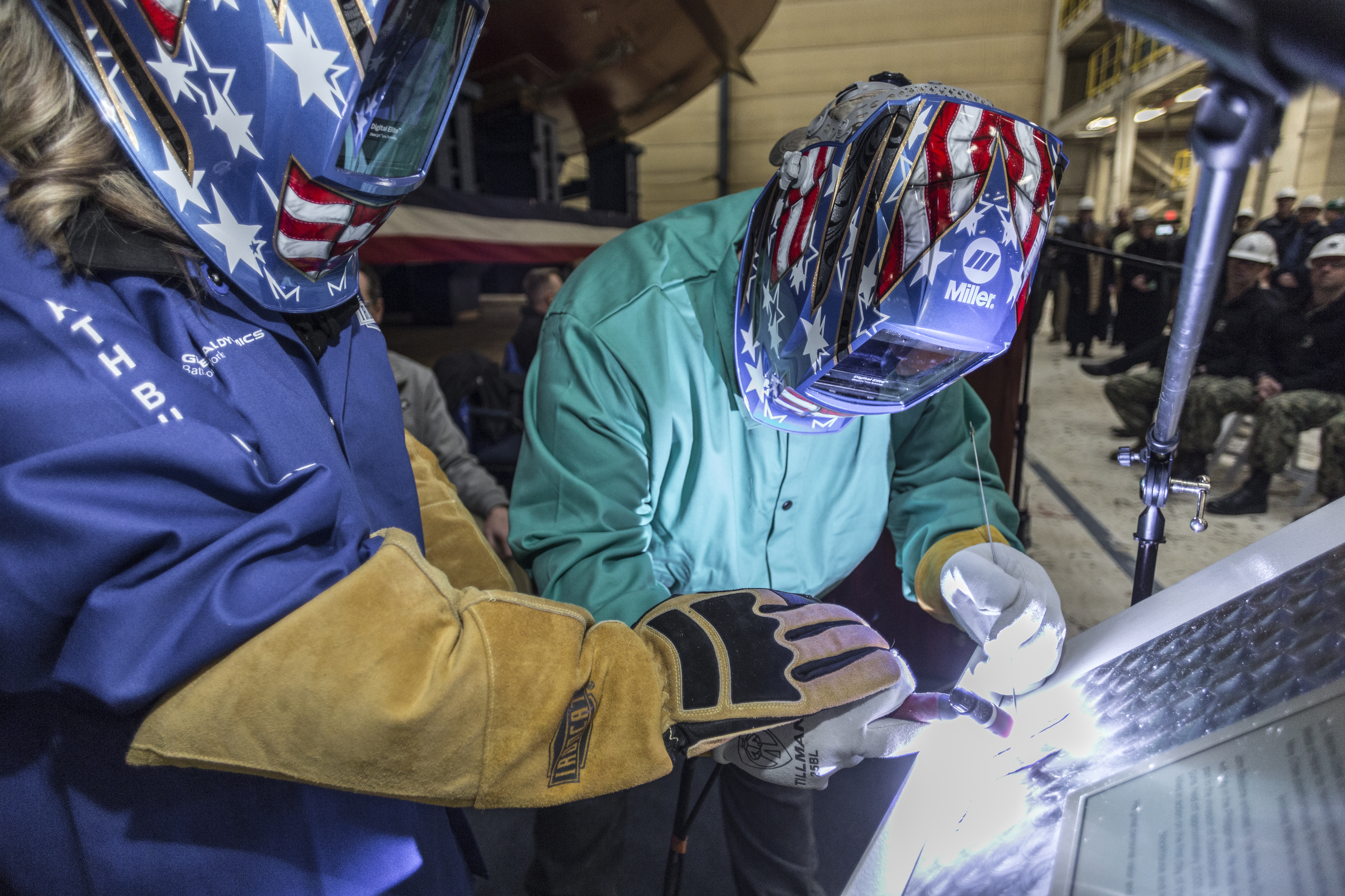 BATH, Maine (Jan. 10, 2020) Ship sponsor Ms. Ryan Manion welds her initials into a steel plate during a keel authentication ceremony for the future USS John Basilone (DDG 122). (Photo courtesy of General Dynamics Bath Iron Works)