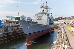 Water is drained from a dry dock at U.S. Naval Ship Repair Facility and Japan Regional Maintenance Center (SRF JRMC) Yokosuka preparing the Ticonderoga-class guided-missile cruiser USS Shiloh (CG 67) for a scheduled maintenance availability. During this maintenance availability, Shiloh will receive multiple repairs and upgrades performed by a combination of Shiloh's crew and SRF JRMC personnel. Shiloh is forward deployed to Yokosuka in support of security and stability in the Indo-Asia-Pacific region. (U.S. Navy photo by Lt. j.g. William McGough)