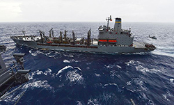 An MH-60S Sea Hawk helicopter assigned to the Dusty Dogs of Helicopter Combat Squadron (HSC) 7 picks up a pallet of supplies from the Military Sealift Command fleet replenishment oiler USNS Leroy Grumman (T-AO 195) during a replenishment-at-sea with the aircraft carrier USS Dwight D. Eisenhower (CVN 69). Dwight D. Eisenhower is underway conducting carrier qualifications. (U.S. Navy photo by Mass Communication Specialist Seaman Anderson W. Branch/Released)