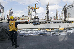 Boatswain's Mate 2nd Class Isiah Price guides a pallet of supplies aboard the guided-missile destroyer USS Porter (DDG 78) during an underway replenishment with the Military Sealift Command fleet replenishment oiler USNS Leroy Grumman (T-AO 195). Porter, forward-deployed to Rota, Spain, is on a routine patrol conducting naval operations in the U.S. 6th Fleet area of operations in support of U.S. national security interests in Europe. (U.S. Navy photo by Mass Communication Specialist 1st Class Sean Spratt/Released)