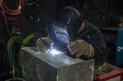 Hull Maintenance Technician 2nd Class A. Lightfoot welds a shelf in the repair shop aboard the aircraft carrier USS Harry S. Truman (CVN 75). The Harry S. Truman Carrier Strike Group is underway conducting training in preparation for a future deployment. (U.S. Navy photo by Mass Communication Specialist Seaman B. Siens/Released)