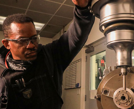 NSWC Corona machinist operate a lathe
