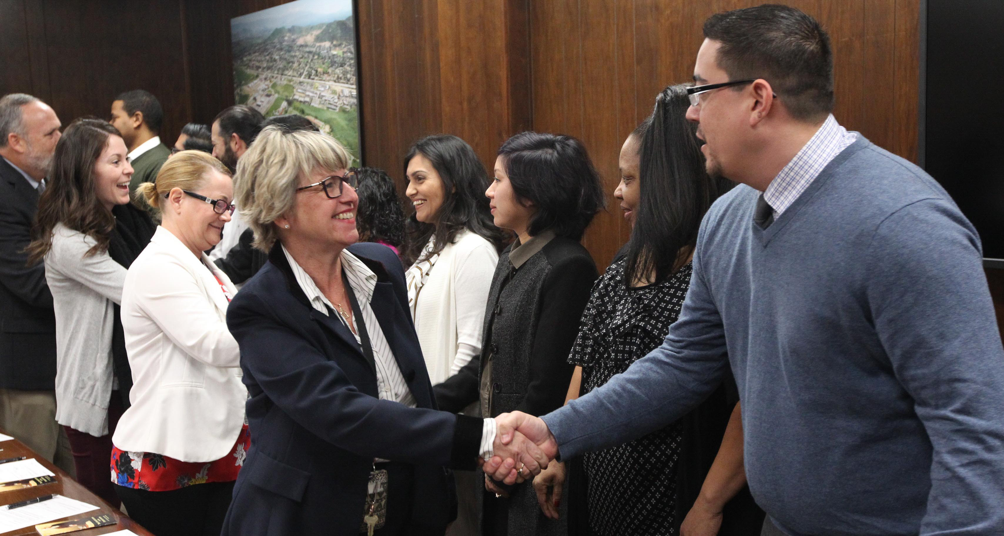 NSWC Corona Technical Director, Dianne Costlow (left) swears in new hires inside the building 512 conference room NSWC Corona Technical Director, Dianne Costlow (left) swears in new hires inside the building 512 conference room