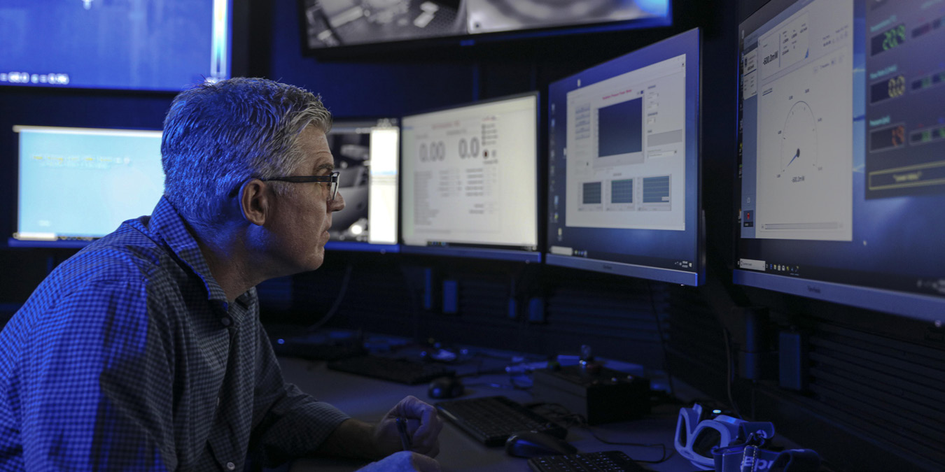 NSWC Corona scientist monitors readings of high energy laser output