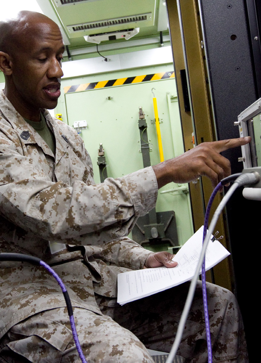 Military personnel operating equipment electronic equipment
