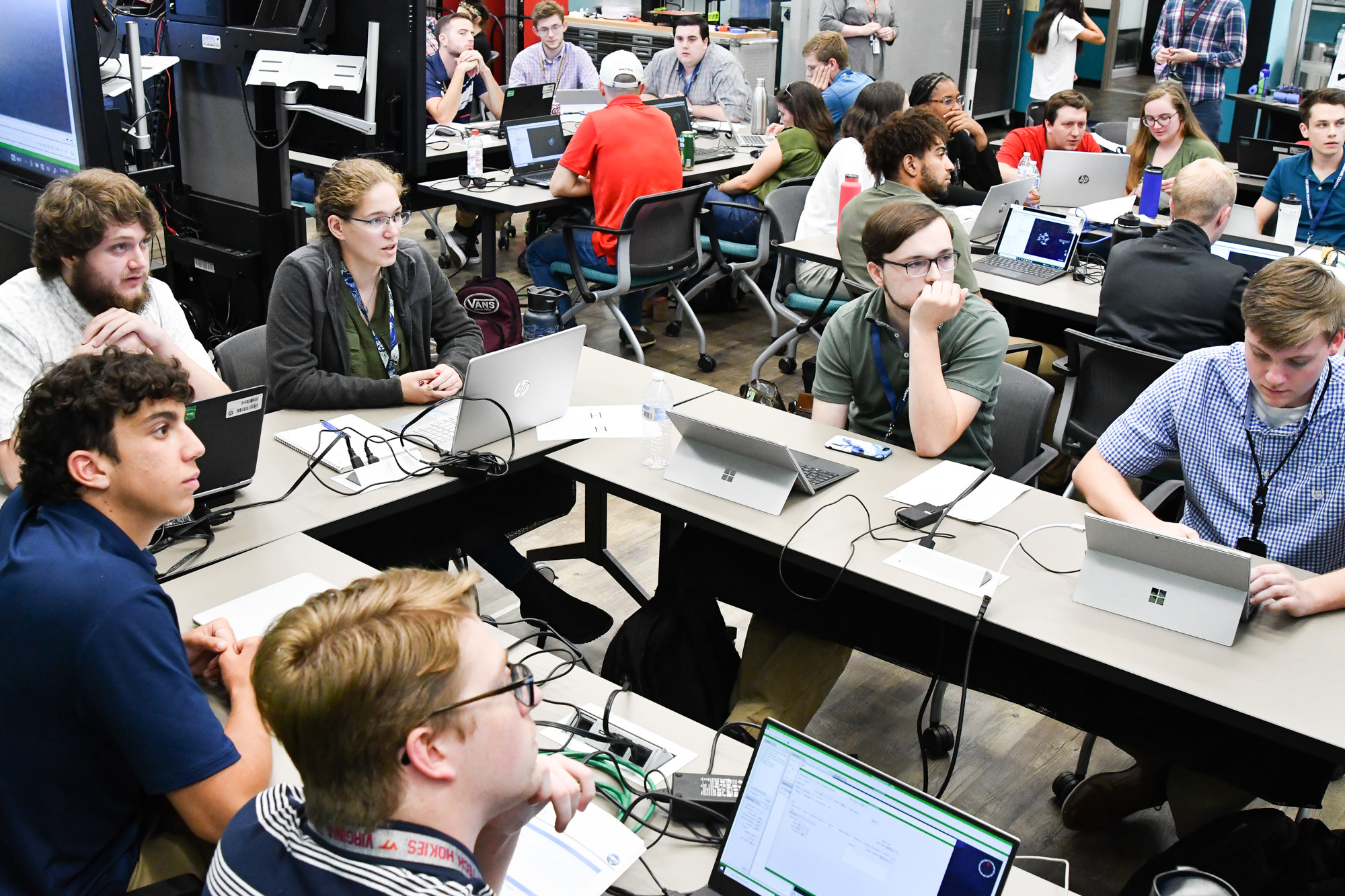 The Weapons Control and Integration Department team of interns watch the big screen as their digital convoy of World War II era U.S. Navy ships battles with enemy U-boats during the Innovation Lab’s Wargaming Hackathon on July 12. After three rounds, the team earned first overall in the competition that featured summer interns from all seven of Naval Surface Warfare Center Dahlgren Division technical departments.