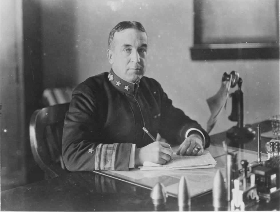 Ralph Earle, seated at his desk. Courtesy of NHHC.