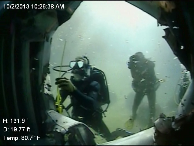 Explosive Ordnance Disposal (EOD) technicians from Technical Support Detachment's Combined Explosive Exploitation Cell (CEXC) measure blast damage on a hull shape during an underwater, post-blast training course. U.S. Navy photo / Released.