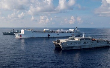 SNS Brunswick (T-EPF 6) and USNS Mercy (T-AH 19), the two primary Pacific Partnership mission platforms, sail in formation with the Royal Canadian Navy's HMCS Vancouver (FFH 331) during a passing exercise (PASSEX) in May, 2018.