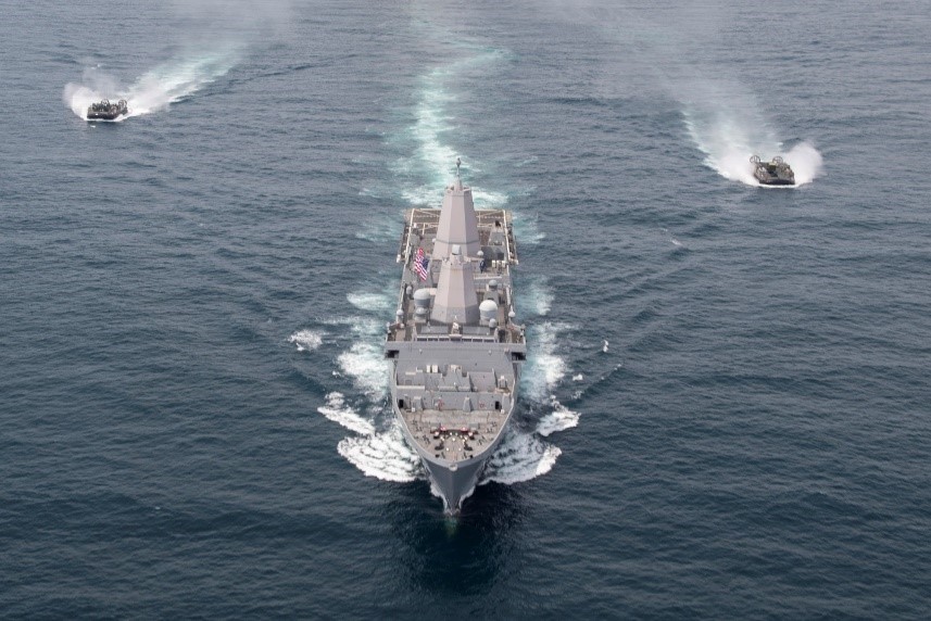 Two landing craft air cushions (LCAC) assigned to Assault Craft Unit (ACU) 5 fly behind the San Antonio-class amphibious transport dock ship USS Somerset (LPD 25). 