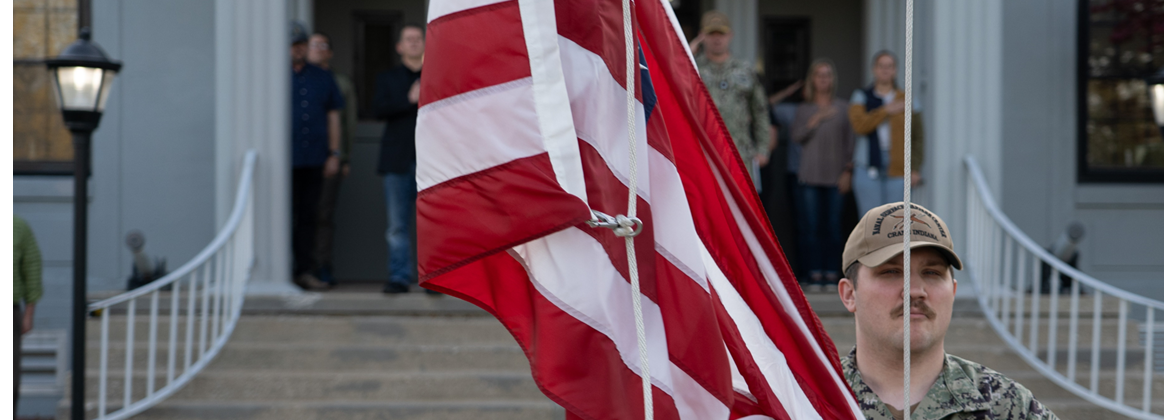 NSWC Crane sailor photographed putting up the U.S. flag in the morning during colors.. 