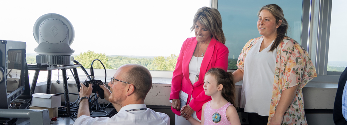 NSWC Crane employees, including NSWC Crane Technical Director, Dr. Angela Lewis, participate in activities during Bring a Child to Work Day.